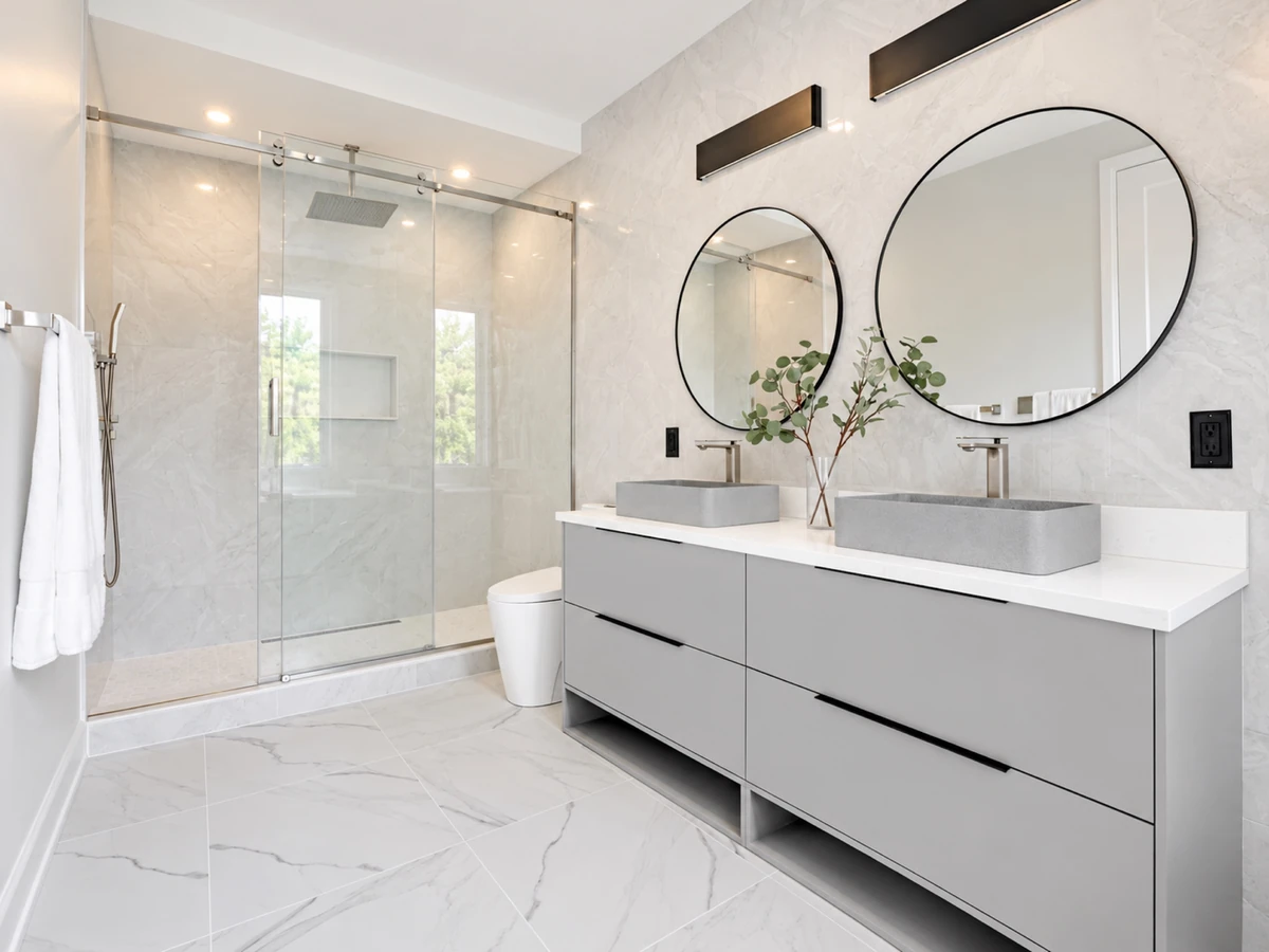 Bathroom with a floating double vanity, glass shower and large-format tile